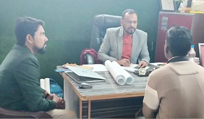 Counsellor speaking with two visitors in the office of a technical training institute in Ballia