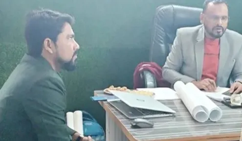 Counsellor speaking with two visitors in the office of a technical training institute in Ballia
