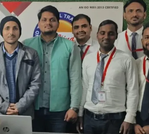 Team members of Al-Hind Technical Training Center in Ballia standing together with ID cards