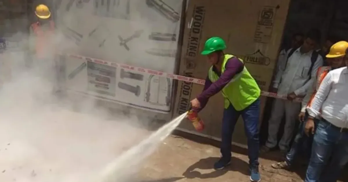 Trainee practising with a fire hose during a safety drill at the technical training institute in Ballia