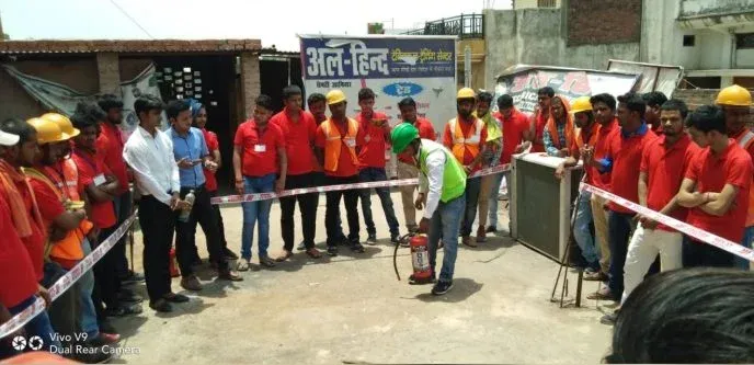 Trainees in red and green jackets lined up for an outdoor safety drill at Al-Hind Technical Training Center